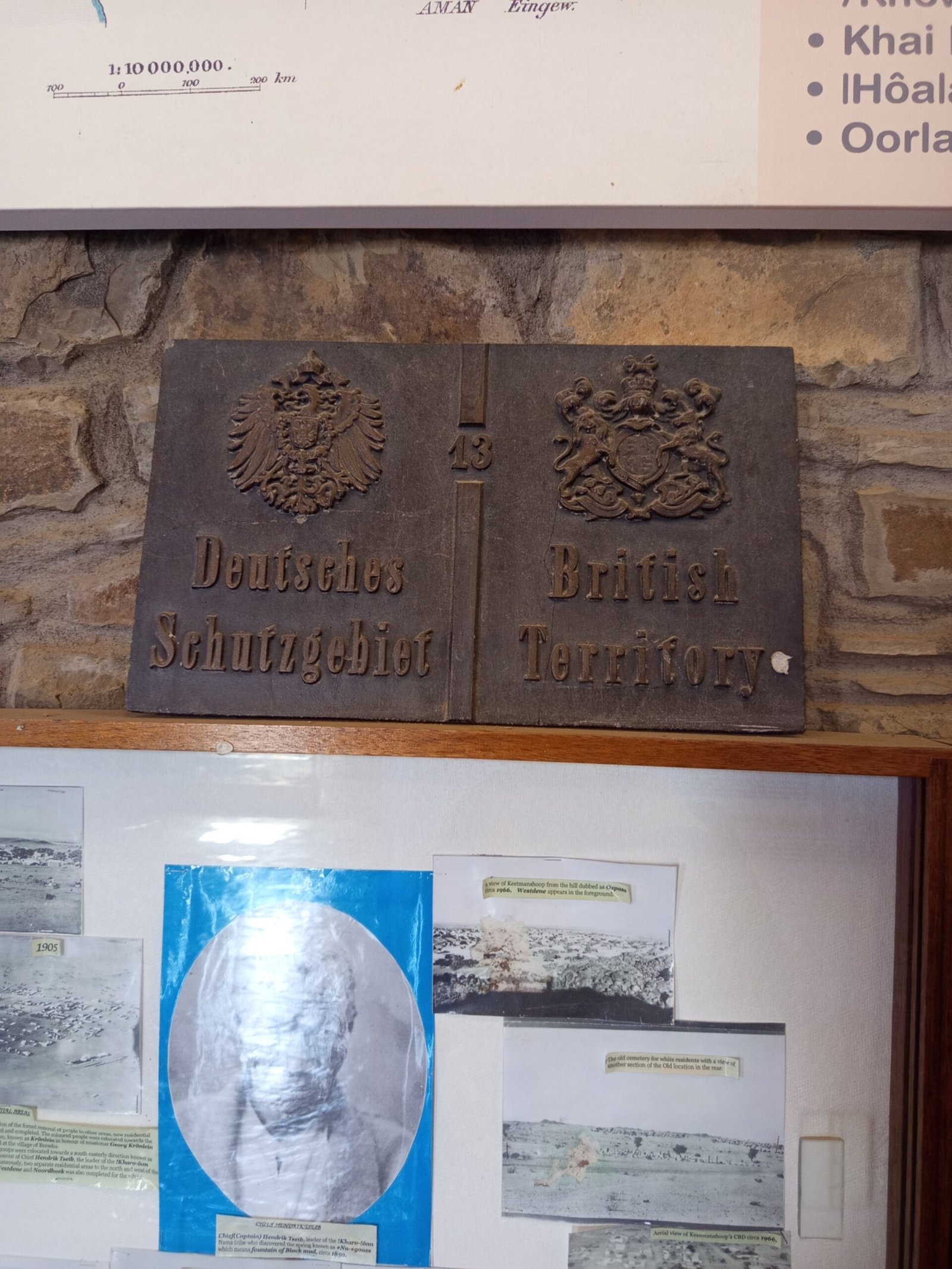 Old border sign: left German Protectorate, right British Territory, with German imperial eagle and British coat of arms